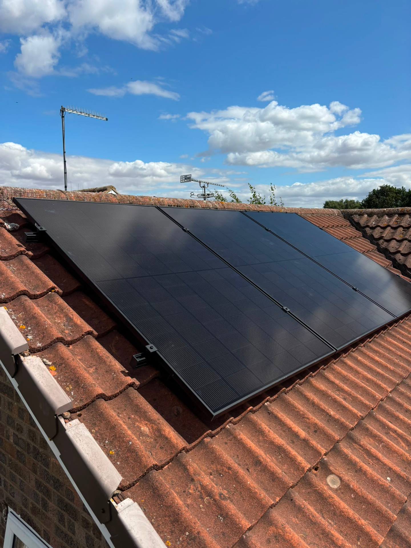 Energix installer fitting a solar panel on a UK rooftop
